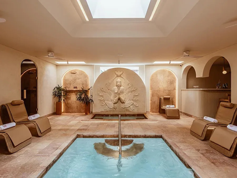 The indoor pool and loungers at ASAI Spa