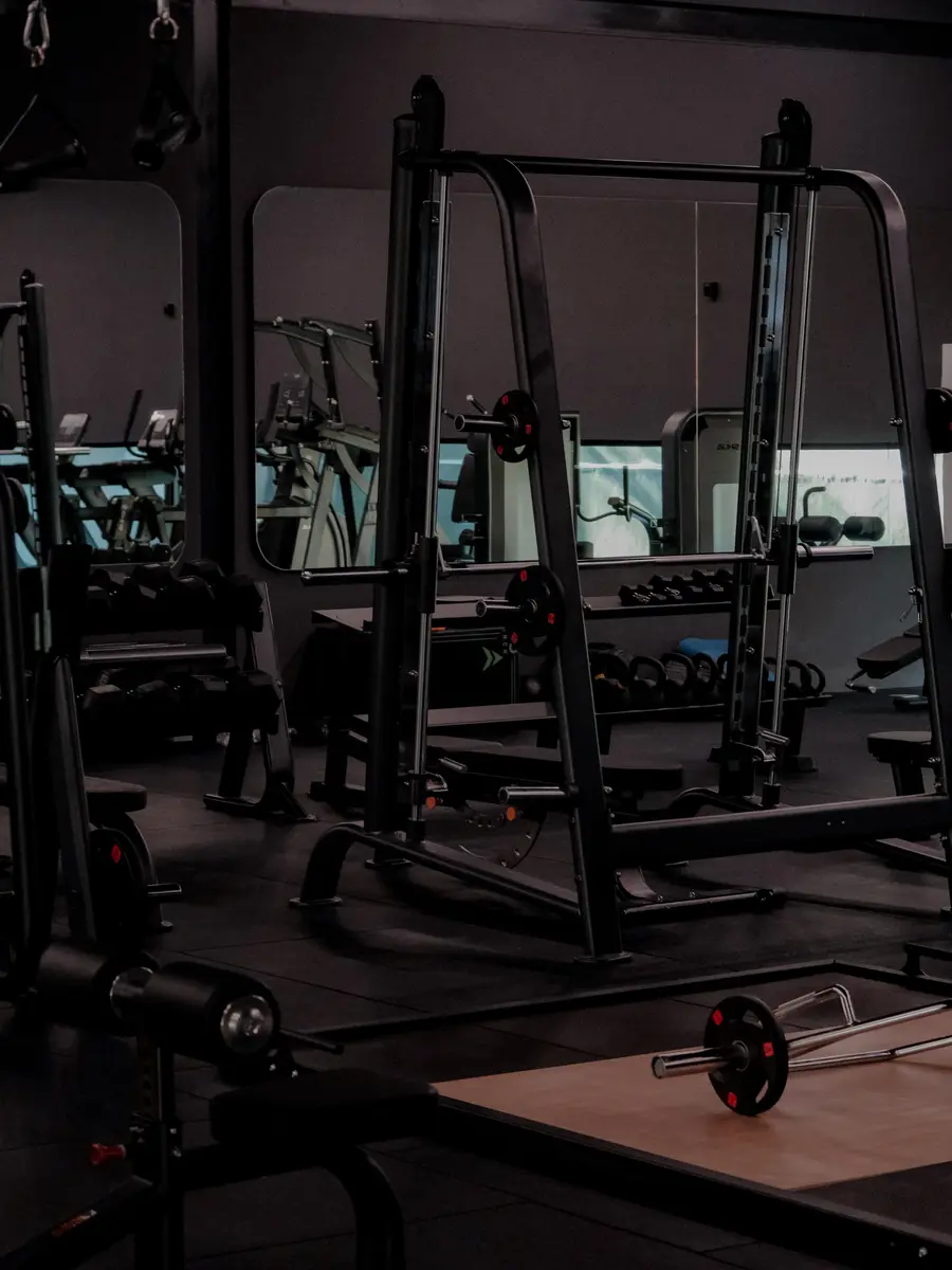 Squat racks, benches and mirrors in the strength area at ASAI GYM